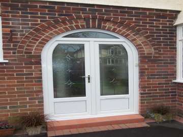 MR R UPTON WIRRAL - White PvcU Arched Door and frame with bespoke leaded lights design at home by JKG leadlighter. Upvc windows wirral